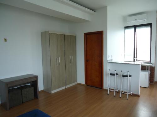 an empty living room with a counter and stools at Hotel St. Daniel in Guarulhos