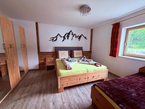 a bedroom with a bed with a mountain sign on the wall at Häringer Mühle in Bad Häring