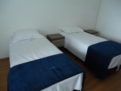 two beds in a small room at Hotel St. Daniel in Guarulhos