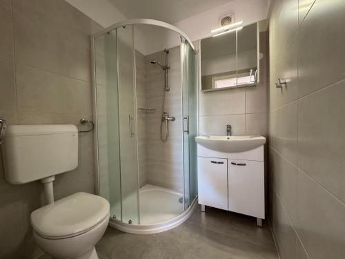 a bathroom with a shower and a toilet and a sink at Guesthouse Villa Stanger in Lovran