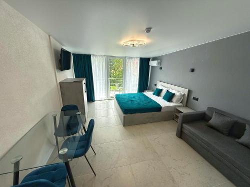 a bedroom with a bed and a couch at VELAR Apartment in Skhidnitsa