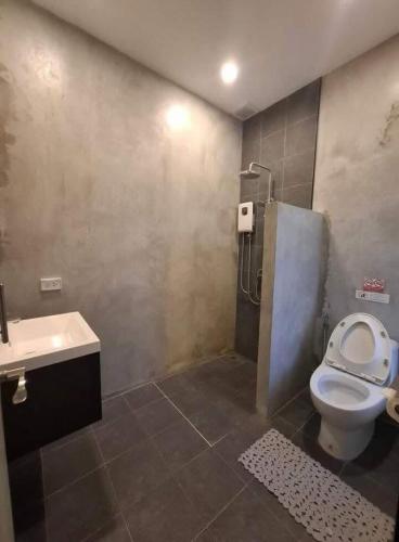 a bathroom with a shower and a toilet and a sink at Ma PoolVilla Khanom in Khanom