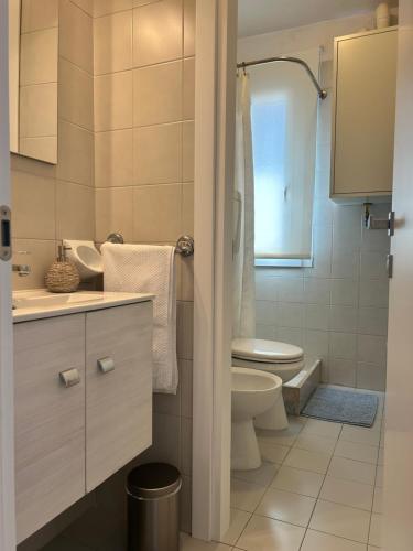 a bathroom with a toilet and a sink at Classense House in Classe
