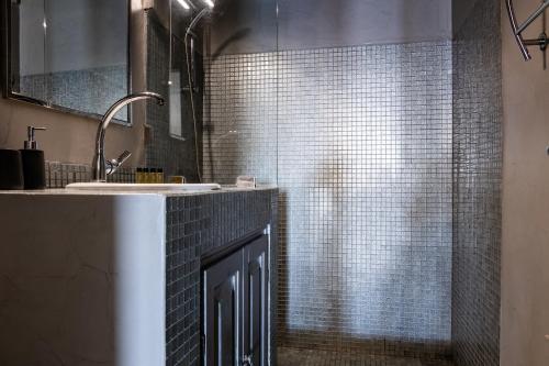 a bathroom with a sink and a shower at Epic View Suites in Akrotiri
