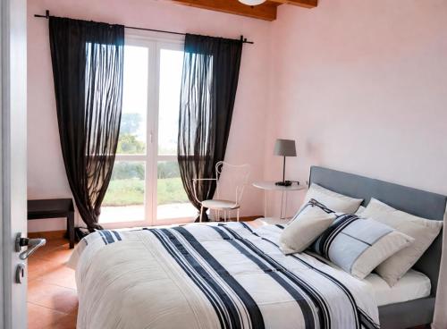 a bedroom with a large bed and a window at Il Nido in Agra