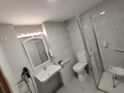 a bathroom with a toilet and a sink and a shower at El Sueño del Infante in Guadalajara