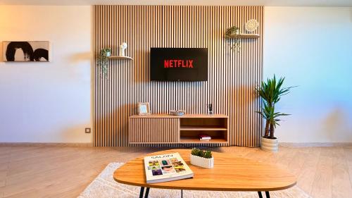 a living room with a tv and a coffee table at Riviera Heights Monaco in Beausoleil