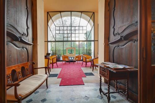 a room with a table and chairs and a large window at Château Liblice in Byšice