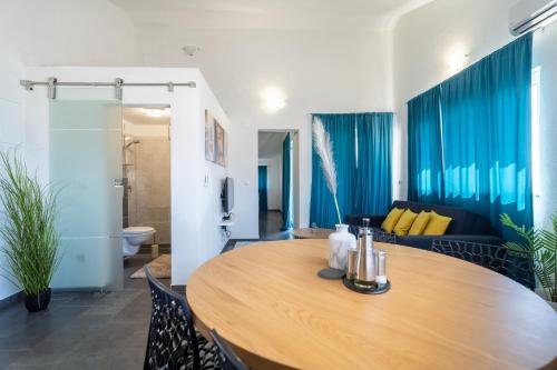 a dining room with a table and a couch at Holiday Apartments Amarilis in Pakoštane