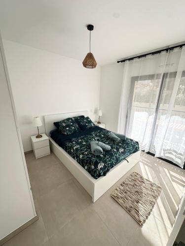 a bedroom with a bed in a room with windows at Suarina in Porto-Vecchio