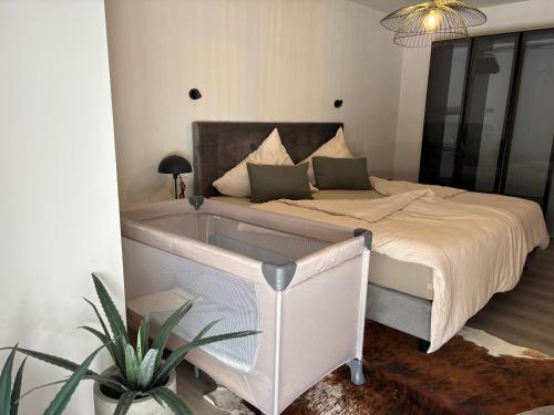 a bedroom with a bed with a tub in it at Moderne Ferienwohnung Ravensburg in Ravensburg