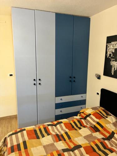 a bedroom with two large white cabinets and a bed at Guest House Persico in Desenzano del Garda