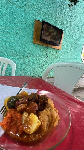 a plate of food on a table with a plate of food at Pousada Oliveira in Cachoeira