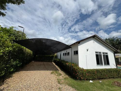 a white building with a large roof on top of it at Casa 007 in Carmen de Apicalá