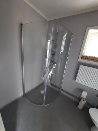 a bathroom with a shower with a glass enclosure at Easystar guest house in Ingarö