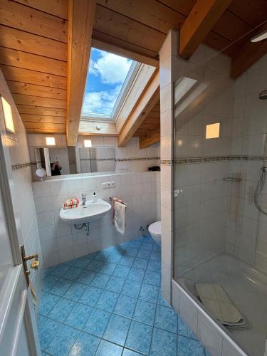 a bathroom with a sink and a shower at Landhaus am Bach in Sulzberg