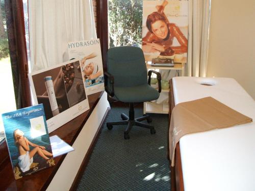 a room with a desk with a chair in it at El Mirador Hotel & Spa in Colonia del Sacramento