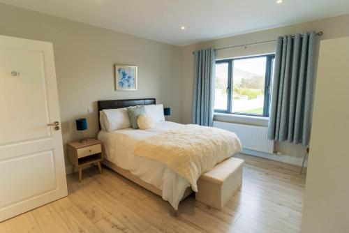 a bedroom with a bed and a window at Carhan House - Cahersiveen in Cahersiveen