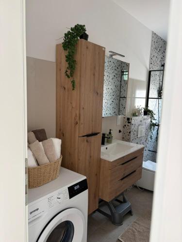a bathroom with a washing machine and a sink at Villa Una Bellevue in Bihać