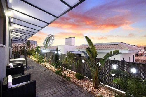 a rooftop patio with a view of a building at Achuza Bamarom in Safed