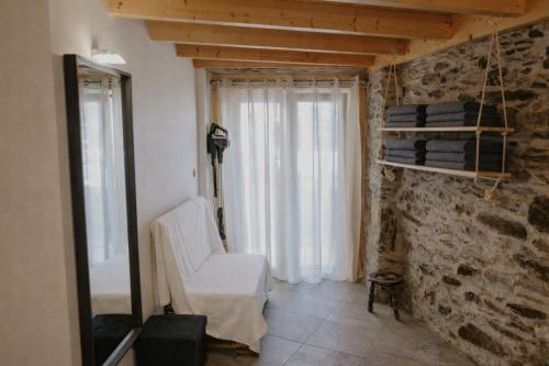 a living room with a white chair and a window at Casa Saudade Vila Real North in Vila Real