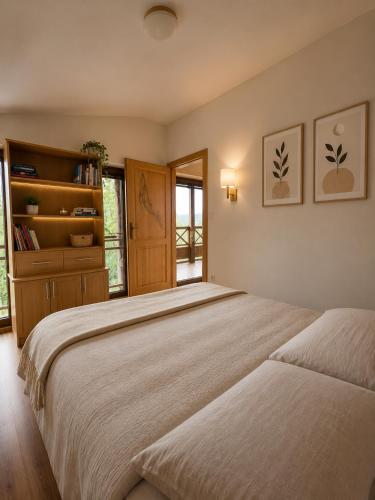 a bedroom with two beds and a book shelf at Villa Sofia - dovolenkový dom pre 8 osôb in Batizovce