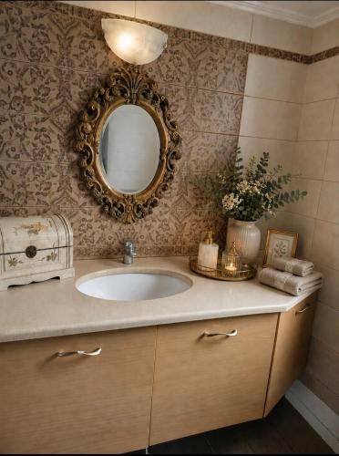 a bathroom with a sink and a mirror at Grace, fifteen minutes drive away from the beach in Kolymvari