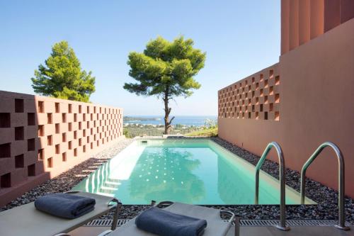 a swimming pool with a view of the ocean from a house at Amandola Villas in Ayia anna