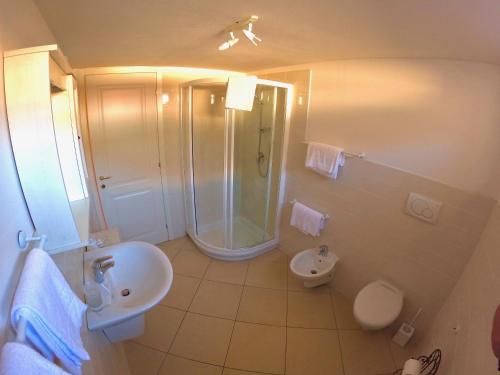 a bathroom with a shower and a sink and a toilet at charmante apartament lake front in Malcesine