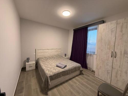 a bedroom with a bed and a large window at Amatuni Guest House in Stepʼanavan