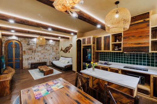 a kitchen with a table and a living room at Little Sun Homestay - Free Buggy Tour check-in Sunset Town in Phú Quốc