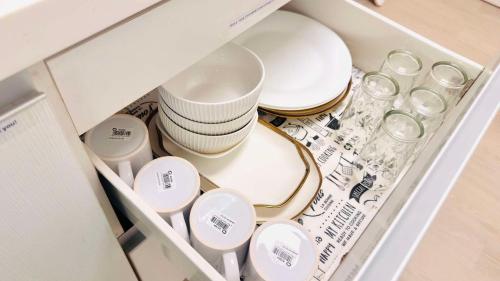 a drawer filled with dishes and bowls and glasses at Terracotta Azure in San Fernando