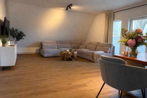 a living room with a couch and a table at Ferienwohnung Gut Lehmhof in Lehmrade