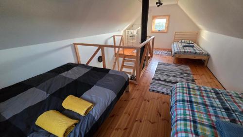 a room with a bed and a staircase in a house at Peeduland Cabin in Kohatu