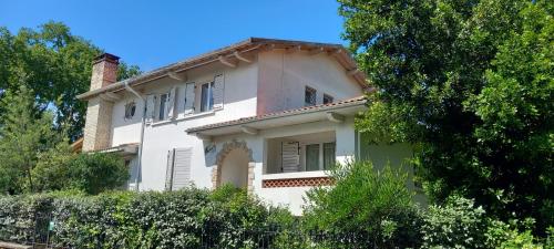 a white house with a chimney on top of it at Villa Do Sol Chambre d'Hôtes "La Dune" in Arcachon