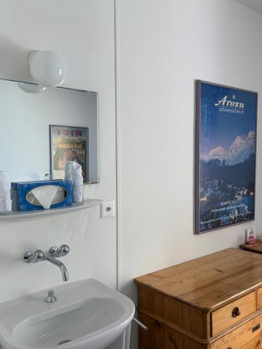 a bathroom with a sink and a mirror at Seehotel Bären in Brienz