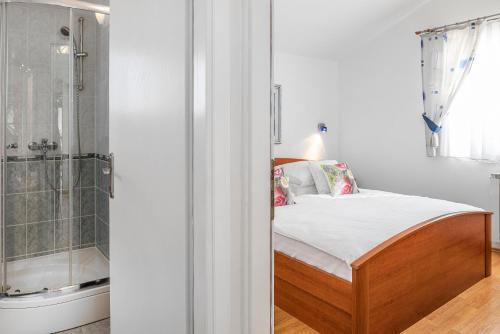 a bedroom with a bed and a shower at Villa Baron - Adriatic Sea View in Šibenik