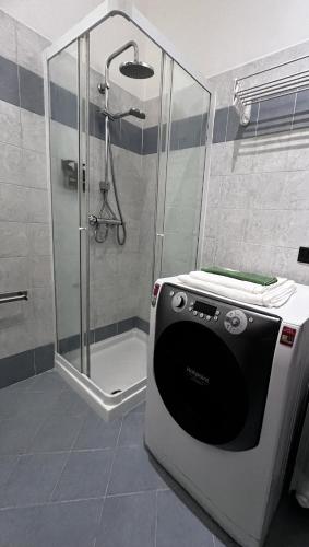 a shower with a glass door in a bathroom at The Water Lodge in Omegna