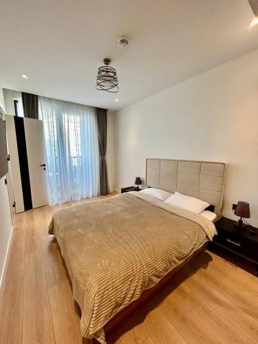 a bedroom with a large bed in a room at NovaStay Apartments in Batumi