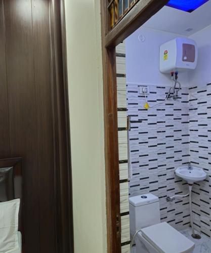 a bathroom with a toilet and a sink at The Hotel Siddhi Residency near Ram Mandir in Ayodhya