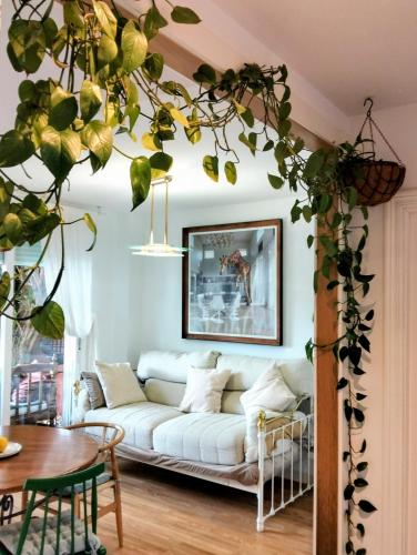 a living room with a white couch and a table at Oasis de Sal y Pradera in Miengo