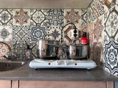 two pots on top of a stove in a kitchen at Bed and Stay Amsterdam in Amsterdam