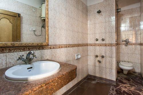 a bathroom with a sink and a toilet at Hotel Sunshine in New Delhi