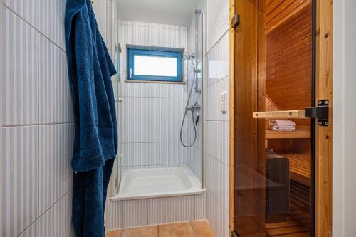a bathroom with a shower and a bath tub at Meeresrauschen 1 in Groß Kirr