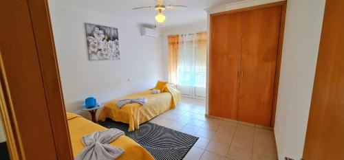 a small room with two beds and a hallway at Vivenda Do Relaxo '' Relax Villa " in Freiria