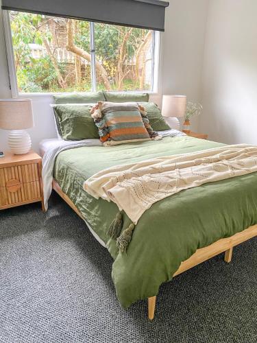 a bedroom with a large bed with a window at Martyr Views in Warburton