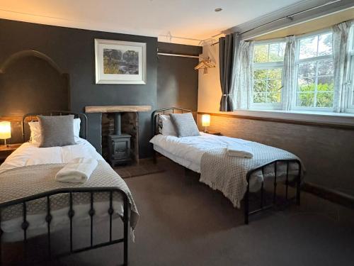 a bedroom with two beds and a fireplace in it at Motel M69 in Leicester