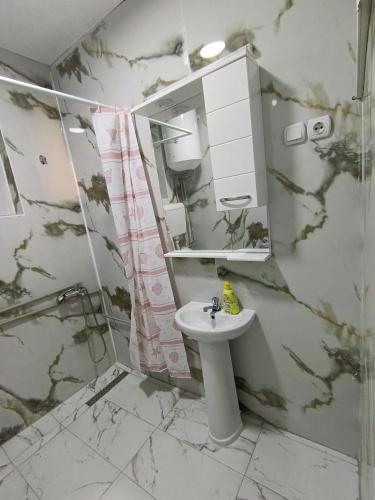 a bathroom with a sink and a shower and a mirror at Travel Hub Hostel Social and Friendly in Ohrid