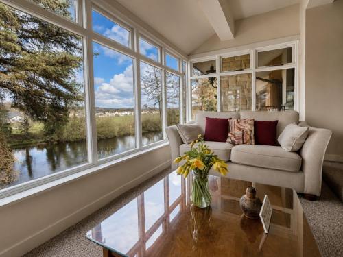 a living room with a couch and large windows at Killarney View House B&B in Killarney