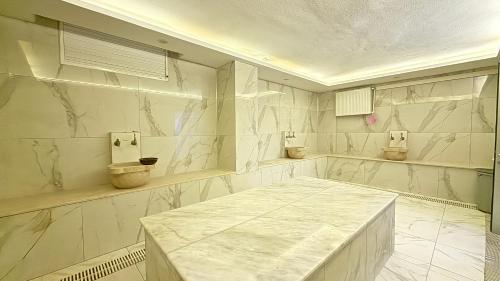 a bathroom with two toilets and a marble counter at Teker Suite Hotel in Mersin